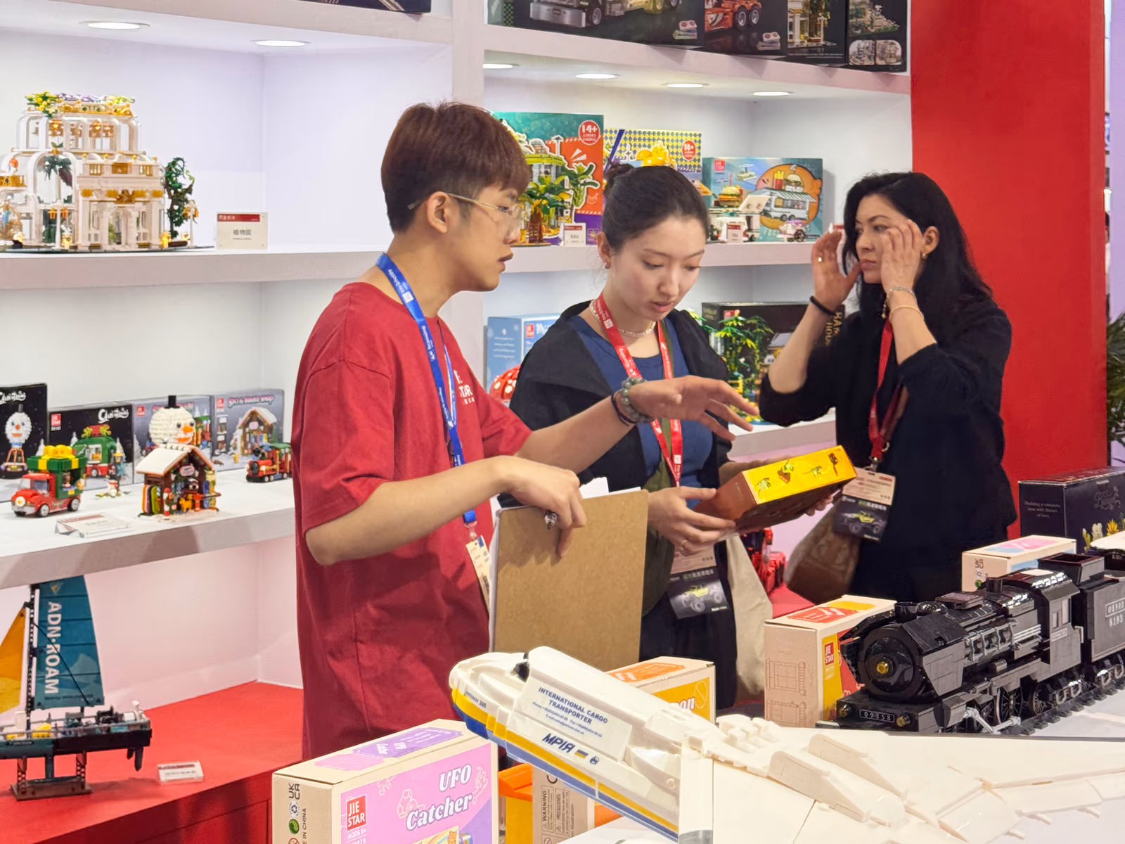 A JIESTAR team member presenting a finished model to visitors at China Toy Expo 2025